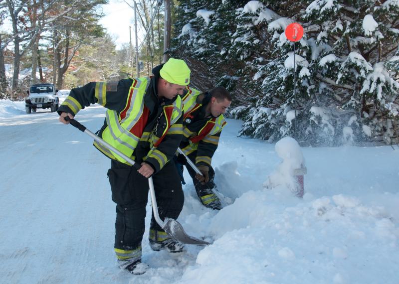 Joel Watters and Dylan Glavin of the Marion Fire Department dig out fire hydrants. BY GEORGIA SPARLING